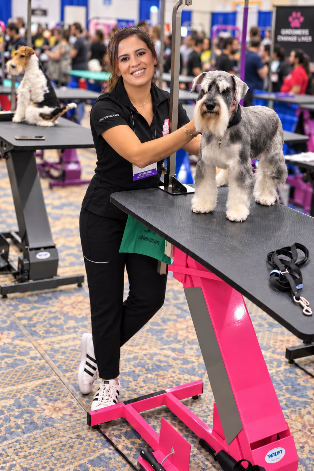 Laura Torrente presenting a groomed schnauzer at a professional grooming event